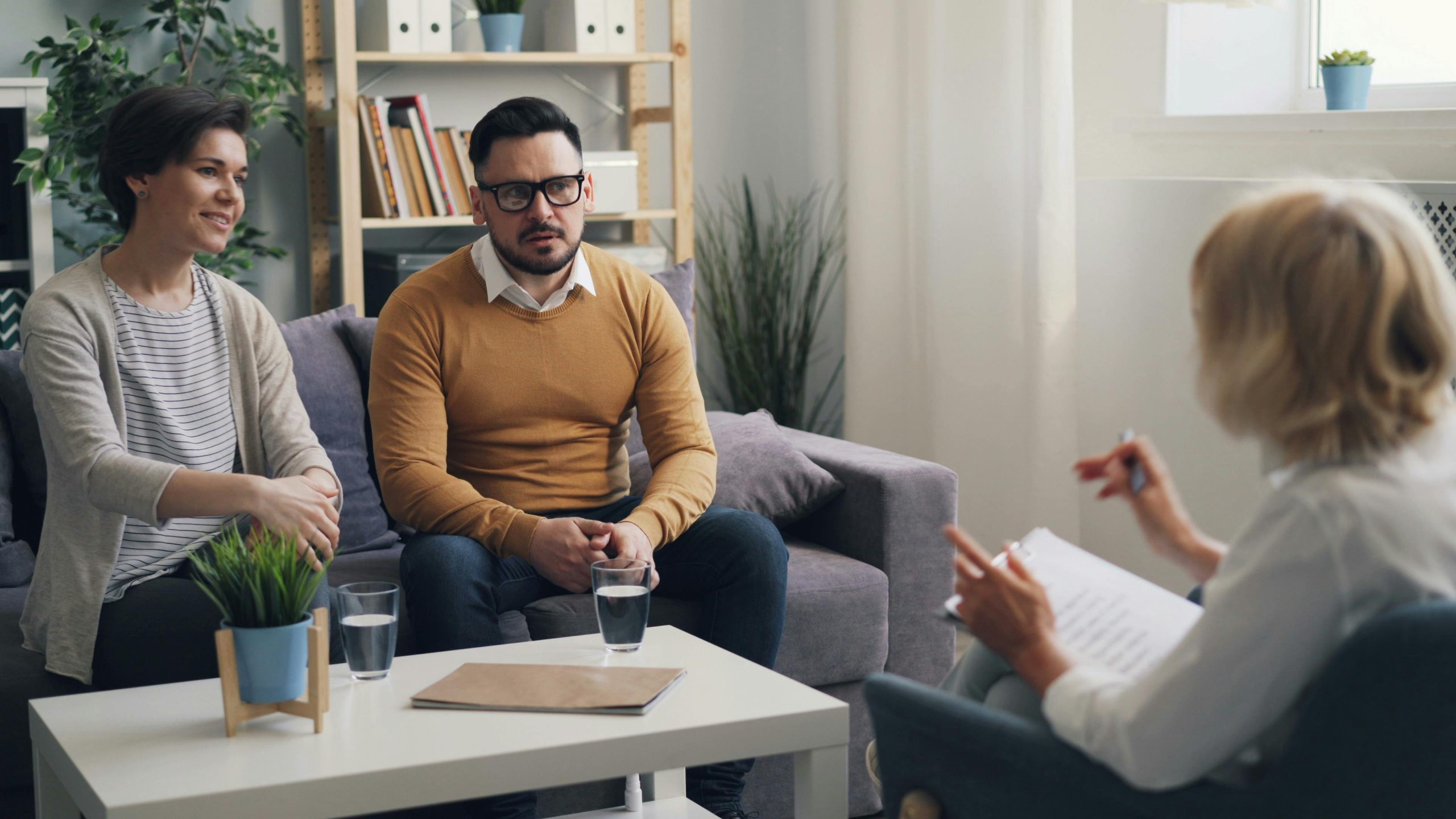 family in a counselling / therapy session talking in a room