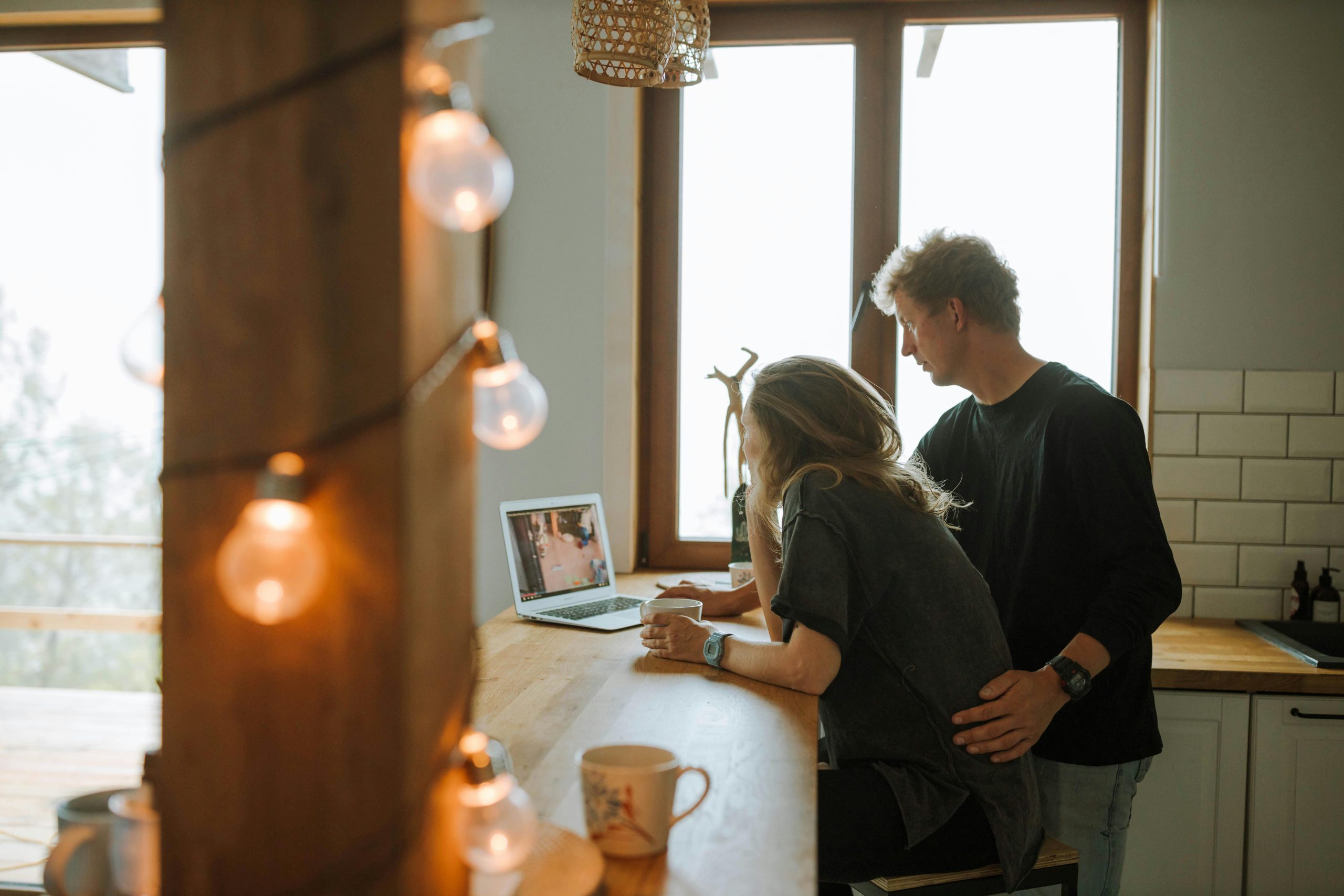 Couple living together - both looking at laptop